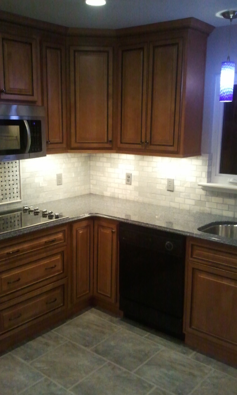 Marble subway tile backsplash on corner kitchen